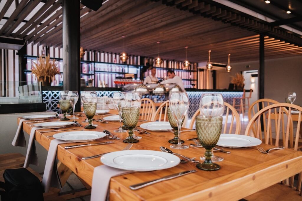 A beautifully set restaurant table with elegant glassware, ready for dining in a stylish interior.